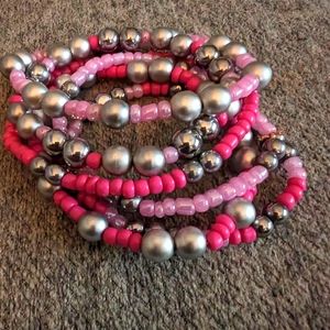 Bundle of pink and silver beaded bracelets.